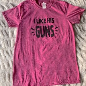 Pink T-shirt “I like his guns.”